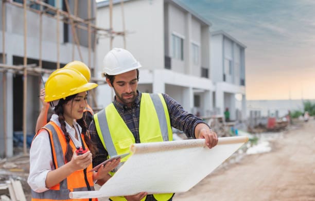 Engineers reviewing plans at a construction site